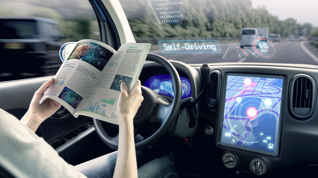 Autonomous Car Cockpit Driver reading a book in cockpit of an autonomous self-driving car.