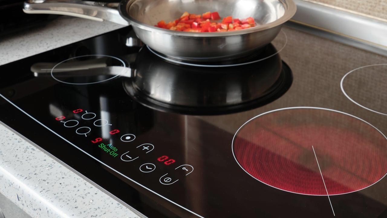 Cooktop Stove with Auto Shut-Off Functional Safety Feature Auto shut-off indicator on control panel turned of modern electric cooking stove for functional safety..