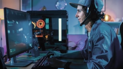 Professional gamer playing online video game on his powerful personal computer