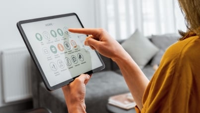 Woman using smart home control on a digital tablet