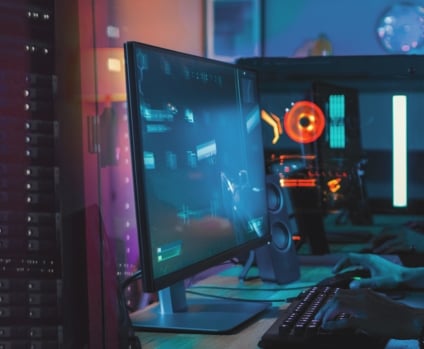 Professional gamer playing online video game on his powerful personal computer