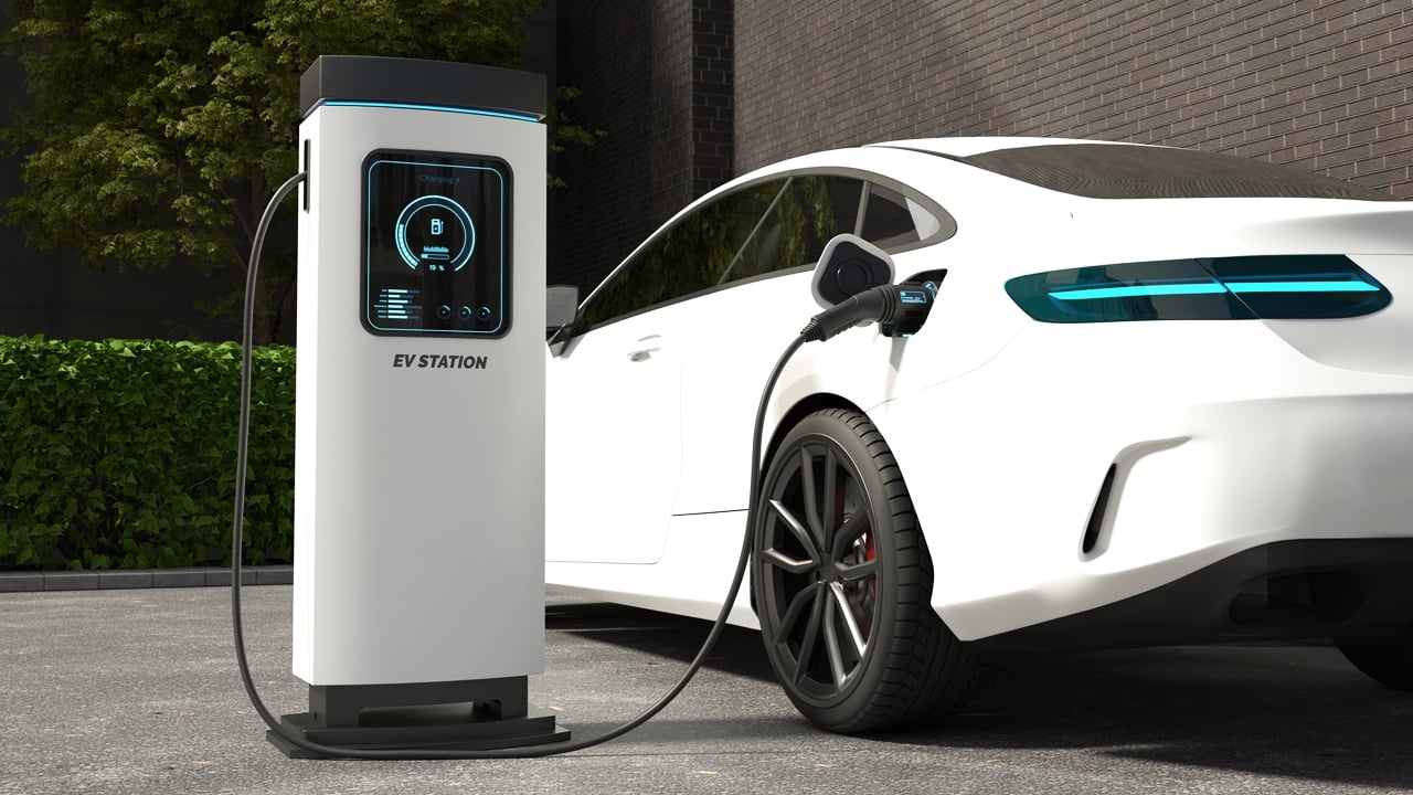 White electric car connected to charging station